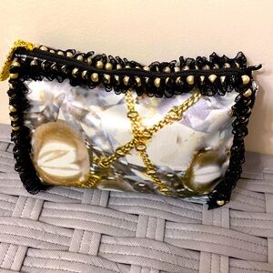 Unique clutch bag with gold chain print design.
